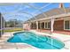 Inviting kidney-shaped pool with screened enclosure and brick patio at 3808 El Conquistador Pkwy, Bradenton, FL 34210
