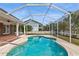 Relaxing kidney-shaped pool with screened enclosure at 3808 El Conquistador Pkwy, Bradenton, FL 34210