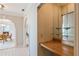 Built-in wet bar with glass shelving and wood countertop at 3808 El Conquistador Pkwy, Bradenton, FL 34210