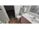 Bathroom with a pink vanity, tiled floor, toilet, and an open doorway at 3935 Panola Ln # 183, Sarasota, FL 34232