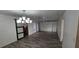 Spacious dining room featuring a modern chandelier and a sliding barn door to another room at 3935 Panola Ln # 183, Sarasota, FL 34232