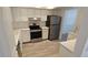 Bright kitchen features new stainless steel refrigerator, oven, and white cabinets and countertops at 3935 Panola Ln # 183, Sarasota, FL 34232