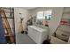 Laundry room with side-by-side washer and dryer, utility sink, and storage shelves at 3935 Panola Ln # 183, Sarasota, FL 34232