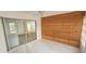 Sunroom with wood accent wall, sliding glass door, and view of the interior at 3935 Panola Ln # 183, Sarasota, FL 34232