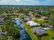 Aerial view of homes on canal featuring lush landscaping, backyard space, and waterfront views at 4423 Meadow Creek Cir, Sarasota, FL 34233