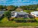 Aerial view showing house, pool, and lush landscaping at 4423 Meadow Creek Cir, Sarasota, FL 34233