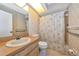 Well-lit bathroom featuring a shower with grab bars for added safety and updated finishes at 4423 Meadow Creek Cir, Sarasota, FL 34233