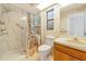 Cozy bathroom featuring neutral walls, a toilet, shower, and sink at 4423 Meadow Creek Cir, Sarasota, FL 34233