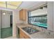 Bright kitchen featuring a double sink and a window view of the inviting pool at 4423 Meadow Creek Cir, Sarasota, FL 34233