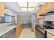 A bright kitchen featuring stainless appliances, granite countertops, and a window at 4423 Meadow Creek Cir, Sarasota, FL 34233