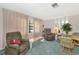 Relaxing living room with a recliner, wood coffee table, and large windows at 4423 Meadow Creek Cir, Sarasota, FL 34233