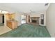 A spacious living room with a brick fireplace and sliding glass doors leading to a pool at 4423 Meadow Creek Cir, Sarasota, FL 34233