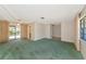 Spacious living room featuring neutral walls, a ceiling fan, and sliding doors to the outside at 4423 Meadow Creek Cir, Sarasota, FL 34233