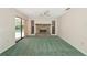 A spacious living room featuring a fireplace and sliding glass doors that lead to a pool at 4423 Meadow Creek Cir, Sarasota, FL 34233