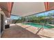 Screened-in pool with lounging area. Enjoy sunny days poolside on brick paving at 4423 Meadow Creek Cir, Sarasota, FL 34233