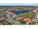 Aerial view of a community featuring homes surrounding a beautiful lake at 4423 Via Del Villetti Dr, Venice, FL 34293