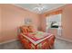 Cozy bedroom with colorful bedding, window with curtains, and neutral carpet at 4423 Via Del Villetti Dr, Venice, FL 34293