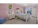 Bedroom with floral bedding, light pink walls, and sliding door with a view to the pool at 4423 Via Del Villetti Dr, Venice, FL 34293