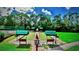 Well-maintained bocce ball courts with covered benches in a lush green community setting at 4423 Via Del Villetti Dr, Venice, FL 34293