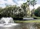 Venetian community entrance features a fountain and lush landscaping with tall palm trees at 4423 Via Del Villetti Dr, Venice, FL 34293