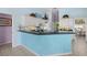 Kitchen with a breakfast bar, white cabinetry and stainless steel appliances at 4423 Via Del Villetti Dr, Venice, FL 34293