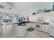 Open kitchen featuring white cabinets, black countertops, and seamless flow into the living area at 4423 Via Del Villetti Dr, Venice, FL 34293