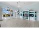 Bright living room featuring ample natural light, custom built-ins, and serene blue walls at 4423 Via Del Villetti Dr, Venice, FL 34293