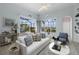 Light and airy living room with sliding glass doors to lanai with a view of the pool and landscaping at 4423 Via Del Villetti Dr, Venice, FL 34293