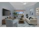 Living room with plush seating, large window with backyard view, and stylish decor at 4423 Via Del Villetti Dr, Venice, FL 34293