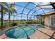 Enclosed pool area featuring a brick-paved deck and a serene view of the adjacent lake and community at 4423 Via Del Villetti Dr, Venice, FL 34293