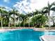 Resort-style pool area surrounded by lush tropical landscaping and lounge chairs at 4423 Via Del Villetti Dr, Venice, FL 34293