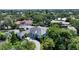 Aerial view of a waterfront home with a gray roof and light blue exterior at 4815 Featherbed Ln, Siesta Key, FL 34242