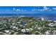 Breathtaking aerial of a neighborhood near the beach and water, featuring the property with a circle marker at 4815 Featherbed Ln, Siesta Key, FL 34242