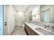 Modern bathroom features a double vanity with marble countertop, and a glass-enclosed shower with herringbone tile at 4815 Featherbed Ln, Siesta Key, FL 34242