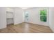 Bedroom featuring wood floors, natural light from windows and closet at 4815 Featherbed Ln, Siesta Key, FL 34242