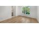 Bedroom featuring beautiful wood floors, bright natural light, and ensuite bathroom at 4815 Featherbed Ln, Siesta Key, FL 34242