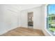 Bedroom with wood floors, closet, and ensuite bathroom access at 4815 Featherbed Ln, Siesta Key, FL 34242