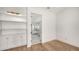 Bedroom featuring a built-in shelving unit, hardwood floors, and doorway leading into the bathroom at 4815 Featherbed Ln, Siesta Key, FL 34242