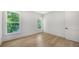 Bedroom with hardwood floors and two windows at 4815 Featherbed Ln, Siesta Key, FL 34242