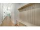 Light-filled hallway with built-in bench and storage at 4815 Featherbed Ln, Siesta Key, FL 34242