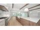 Open kitchen with large island and access to outdoor patio at 4815 Featherbed Ln, Siesta Key, FL 34242
