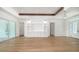 Spacious living room with hardwood floors, built-in shelving, and high ceilings at 4815 Featherbed Ln, Siesta Key, FL 34242