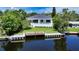 Back of house with private dock, pool, and lush landscaping offering ultimate outdoor living at 4815 Featherbed Ln, Siesta Key, FL 34242