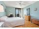 Bright bedroom with hardwood floors, desk, balcony access, and dresser at 4822 Ocean Blvd # 8B, Sarasota, FL 34242