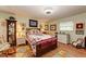 Cozy bedroom with hardwood floors and a display cabinet for keepsakes at 5003 86Th Street W Ct, Bradenton, FL 34210