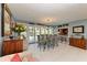 Bright dining room with pool views, an elegant chandelier, and a modern glass table at 5003 86Th Street W Ct, Bradenton, FL 34210