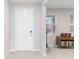 Bright entryway with white door, tile floor and coat rack at 5225 Grove Mill Loop, Bradenton, FL 34211