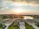 Two-story home with manicured front yard, three-car garage, and pond view at 5225 Grove Mill Loop, Bradenton, FL 34211