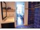 Bathroom with blue tile shower, vanity, and a view of a bedroom at 5311 Creek Dr, Sarasota, FL 34231