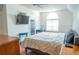 Main bedroom with large bed, French doors, and a teal side table at 5311 Creek Dr, Sarasota, FL 34231